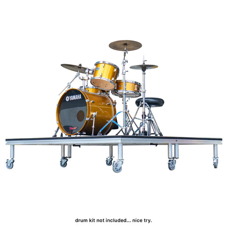 Drum Kit setup atop a drum riser on wheelss.